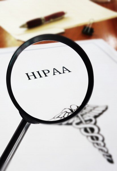 Magnifying glass magnifying the word HIPAA on a document